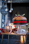 Panettone on table in front of festively decorated fireplace