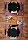 Elegantly laid table with gold cutlery