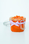 Homemade jam jar of peaches with bow