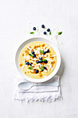 Tropical smoothie bowl with mango, pineapple and coconut yogurt
