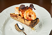 Grilled shrimps and white rice served on plate on table
