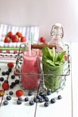 Colourful smoothies in a wire basket