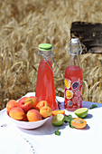 Summer lemonades with apricots and limes on a garden table