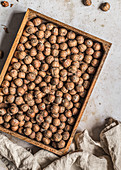 Raw hazelnuts in a wooden tray