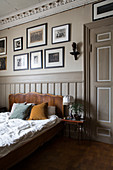 Panelled door, wainscoting and stucco ceiling in bedroom