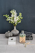 White lilac in structured vase, deck of cards and matches
