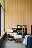 Eames Lounge Chair in modern interior with wood-panelled wall