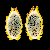 A sliced yellow pitahaya against a black background