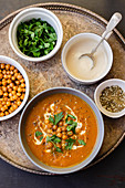 Carrot soup with baked chickpeas, tahini, zaatar and parsley