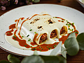 Hake and txangurro cannelloni with oxtail served with bechamel sauce