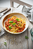 Spaghetti with bolognese sauce, parmesan cheese and basil