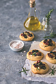 Mini focaccias with garlic, sun dried tomatoes, olives and rosemary