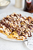 Pancakes with chocolate sauce and nuts