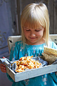 Girl holding plate with cheese stars