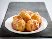 Freshly baked profiteroles on a plate