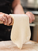Rolling out a dough sheet with a rolling pin