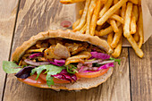 Beef doner, French fries, tomato, greens, arugula, cabbage
