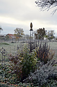 Trellis in the late autumn shrub bed with hoarfrost