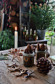 Christmas arrangement of candle, pine cones and antlers
