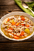 Chicken soup with mussel pasta and carrots