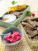 A selection of cheese with crispbread and rhubarb compote