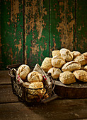 Artisan rolls in a bread basket and beside it