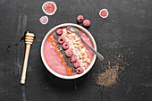 A raspberry smoothie bowl with bananas
