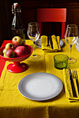 Bowl of apples on table set with yellow cloth