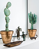 Arrangement of cactus sculptures and bronze figurines