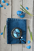Blue Easter egg decorated with denim ribbon