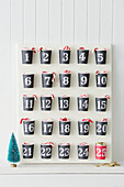 Advent calendar handmade from paper cups with numbered stickers