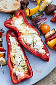 Stuffed pointed peppers with feta cheese and grilled vegetable skewers