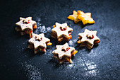 Vegan almond biscuits filled with star-fruit and jam