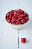 Fresh Raspberries on Napkins in Grass; Picnic Basket