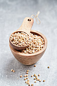 Buckwheat in a wooden bowl and a wooden scoop