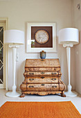 Baroque chest of drawers between two classic standard lamps