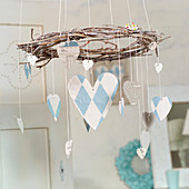 Mobile of paper hearts hanging from vine wreath