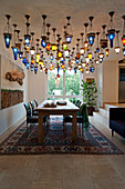 Multiple Oriental ceiling lamps above dining table in open-plan interior