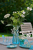 Queen Anne's lace and phlox in blue vase on terrace table