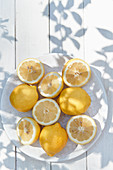 Lemons, whole and halved, on a plate