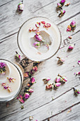 Chai lattes with rose petals and ice cubes