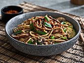 An udon noodle bowl with vegetables