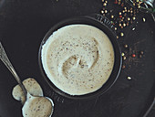 White BBQ sauce with ground pepper