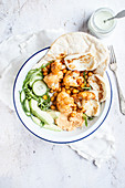 Vegetarian shawarma made with chickpeas and cauliflower, served with naan bread and fried halloumi cheese