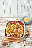 Courgette stuffed with lentils, baked in tomato sauce with beans