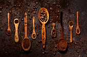 Coffee beans and Ground Coffee on Wooden Spoons in a row