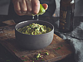 Guacamole being drizzled with lime juice