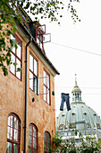 Trousers hung from washing line between period buildings in front of a domes roof in Copenhagen