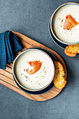 Cream of celery soup with smoked salmon and garlic bread