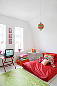 Large red beanbag in living room with colourful accents